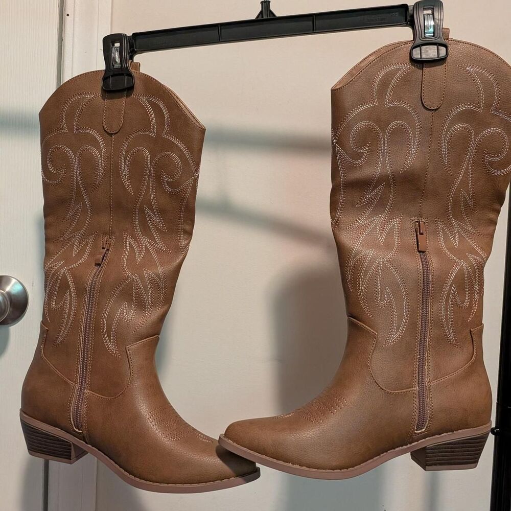 Brown cowboy boots with white embroidered swirls